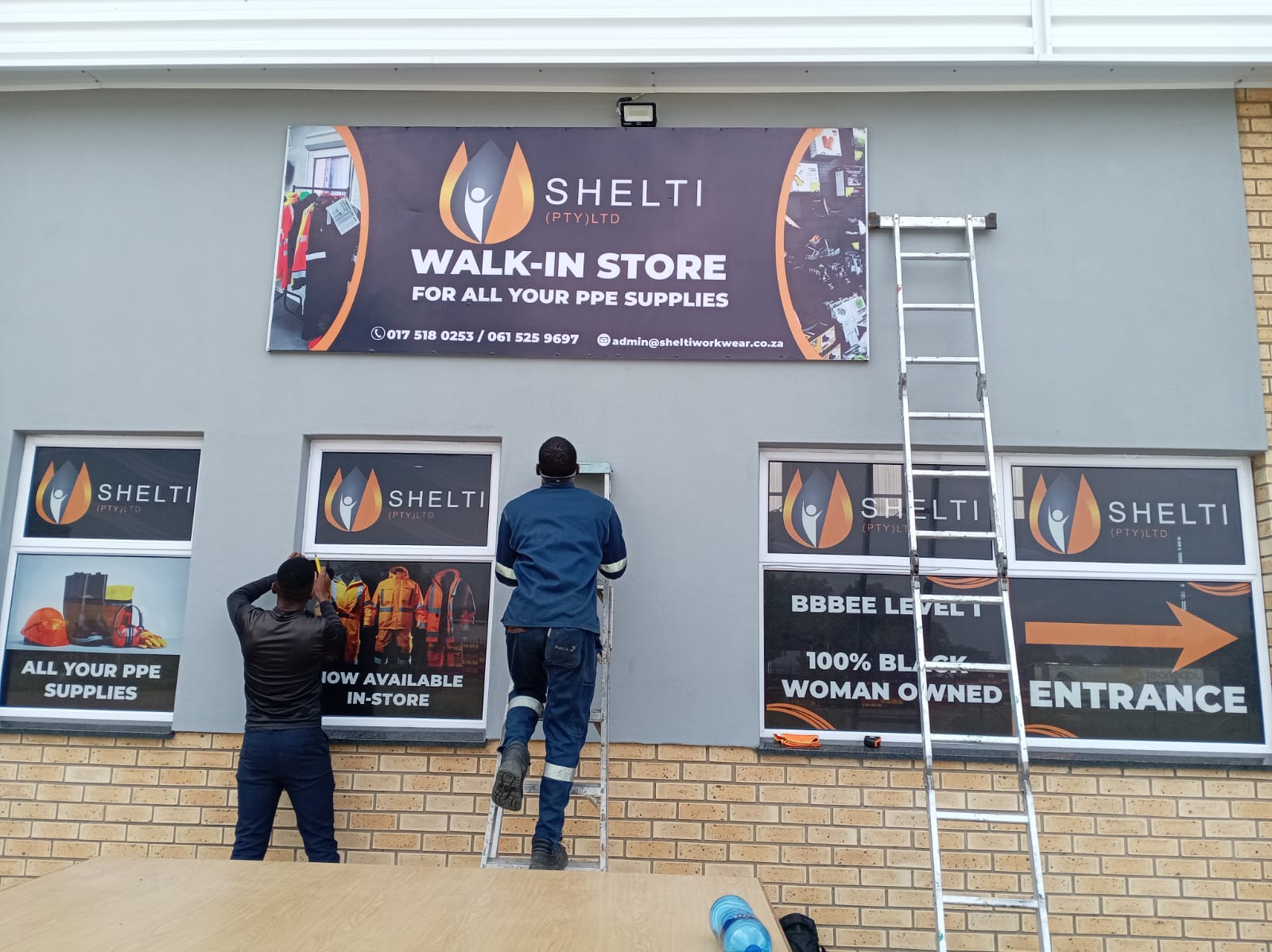 Storefront signage installation for Shelti workwear store